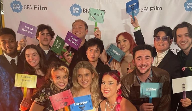 Photo of BFA Film students standing together in front of a step and repeat at the BFA Film thesis showcase