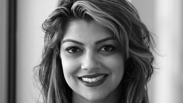 Black and white portrait of Jasmine Wahi smiling