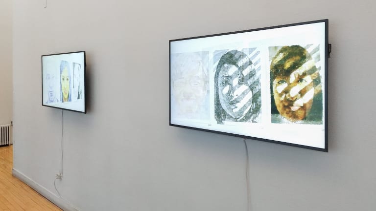 Installation view of two monitors on a wall displaying videos, each screen showing three different portraits by students. 