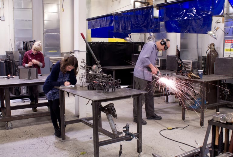 Artists working in the metal shop at SVA. 