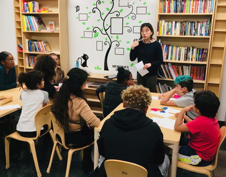 a student-teacher in front of elementary school students