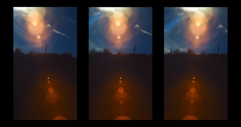 Video Still by artist Jeremy Haik.  Image is divided into three frames, each depicting a horizon with a blue sky and fence post, there is a red and gold lens flare.