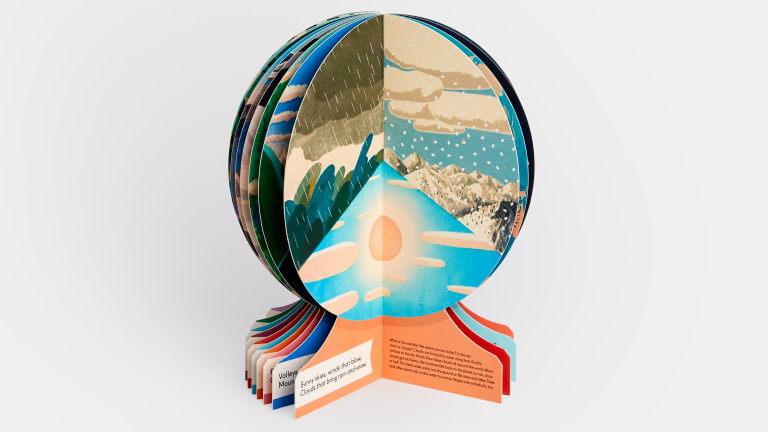 A photograph of a book that is shaped such that when it is open, it looks like a globe on a pedestal.