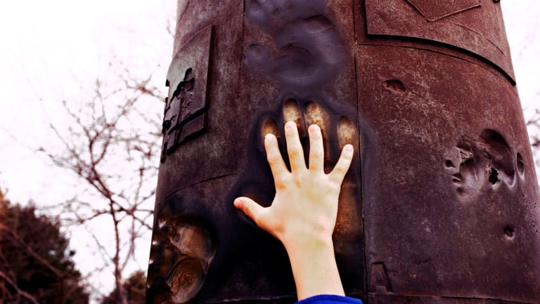 hand touching a pillar