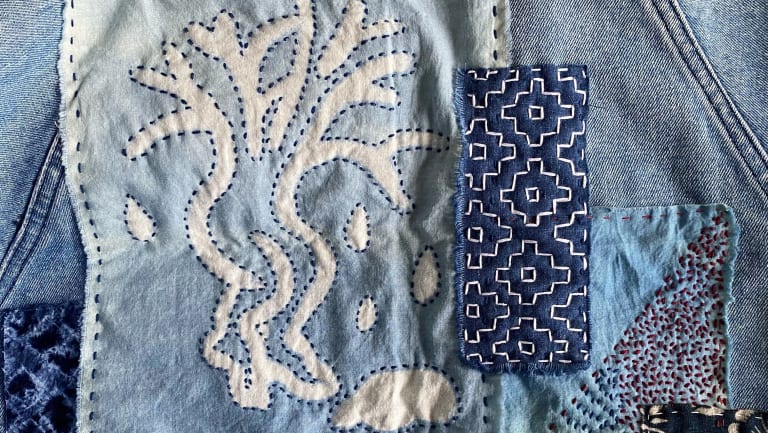 Image of fabric dyed in indigo with intricate patterns