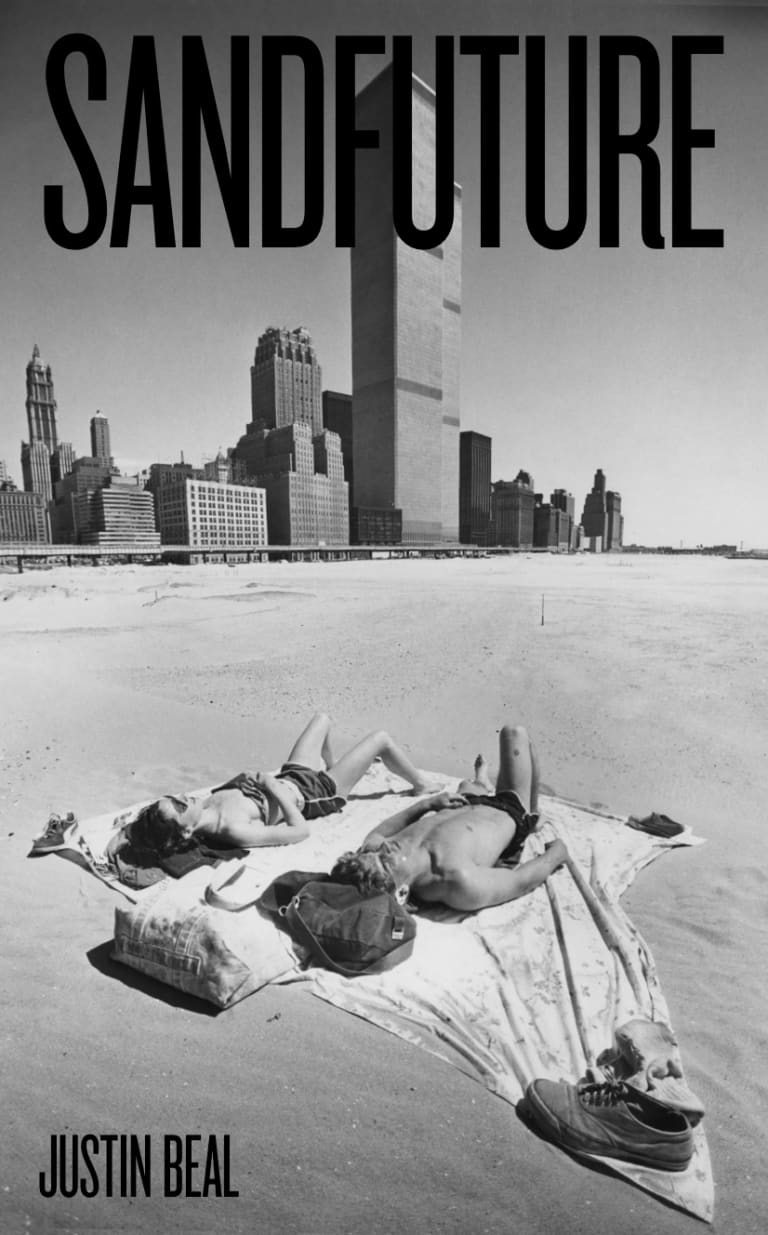 Cover of the book Sandfuture by Justin Beal, with the title at the top and the author’s name at the bottom in black sans-serif font, superimposed over a black and white photo of two people sunbathing in the middle of a barren desert in the foreground, with a large modern city with tall buildings in the distant background at least a mile away.