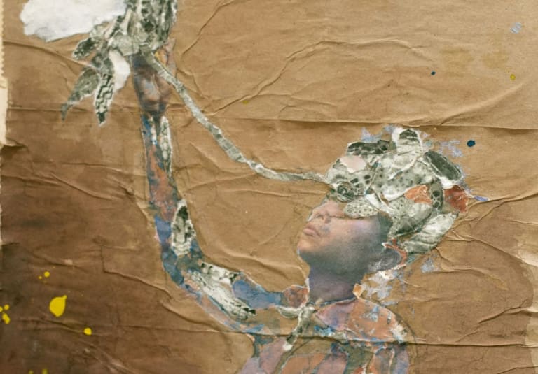 A detail of a collage by Savio Zigbi-Johnson. The collage shows a human figure with the right arm extended upwards to the sky. The background is brown paper.