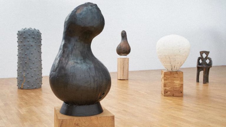 Five ceramic sculptures in a gallery.