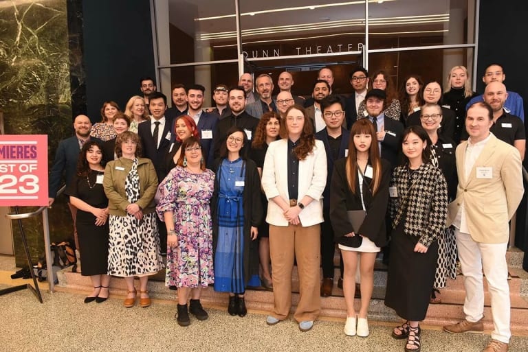 A large group of people standing together posing for a group photo.