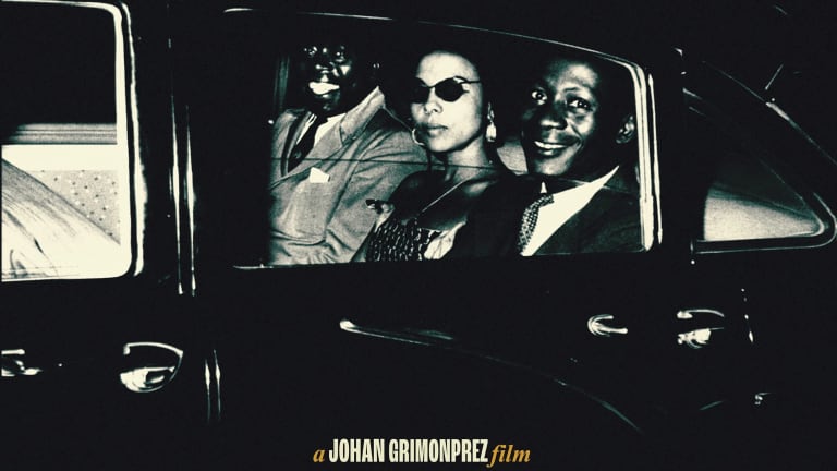 Three people sitting in car with text "A Johan Grimonprez film"