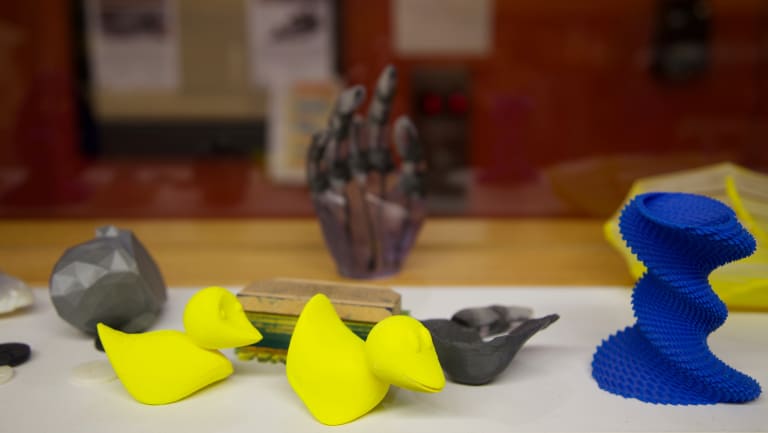 A photograph of three small 3D printed objects
