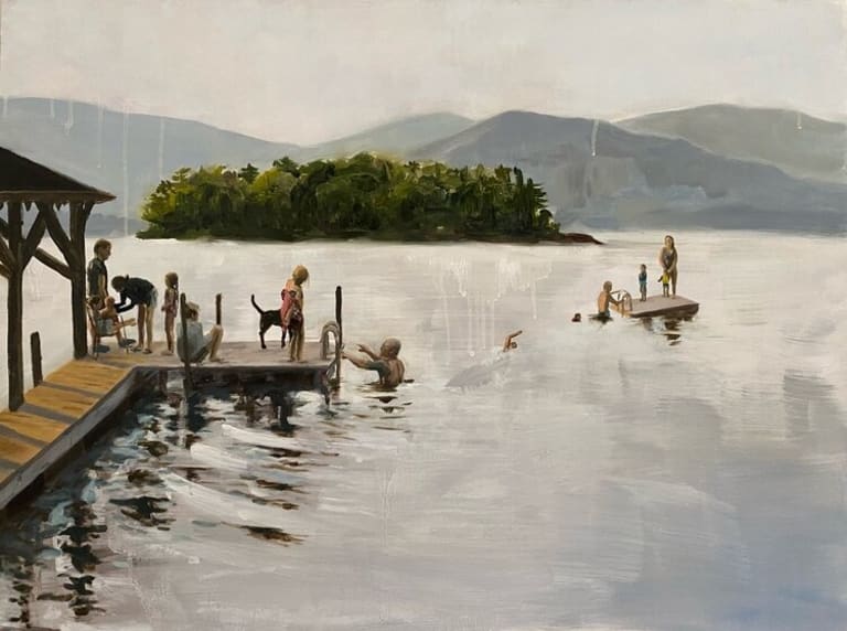A multigenerational group of people enjoys swimming at a pier on a mountain lake with a small forested island in the center of it.
