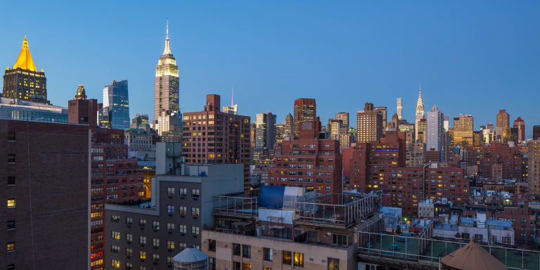 A skyline showcasing differently sized buildings, some made of brick, others made of concrete. 