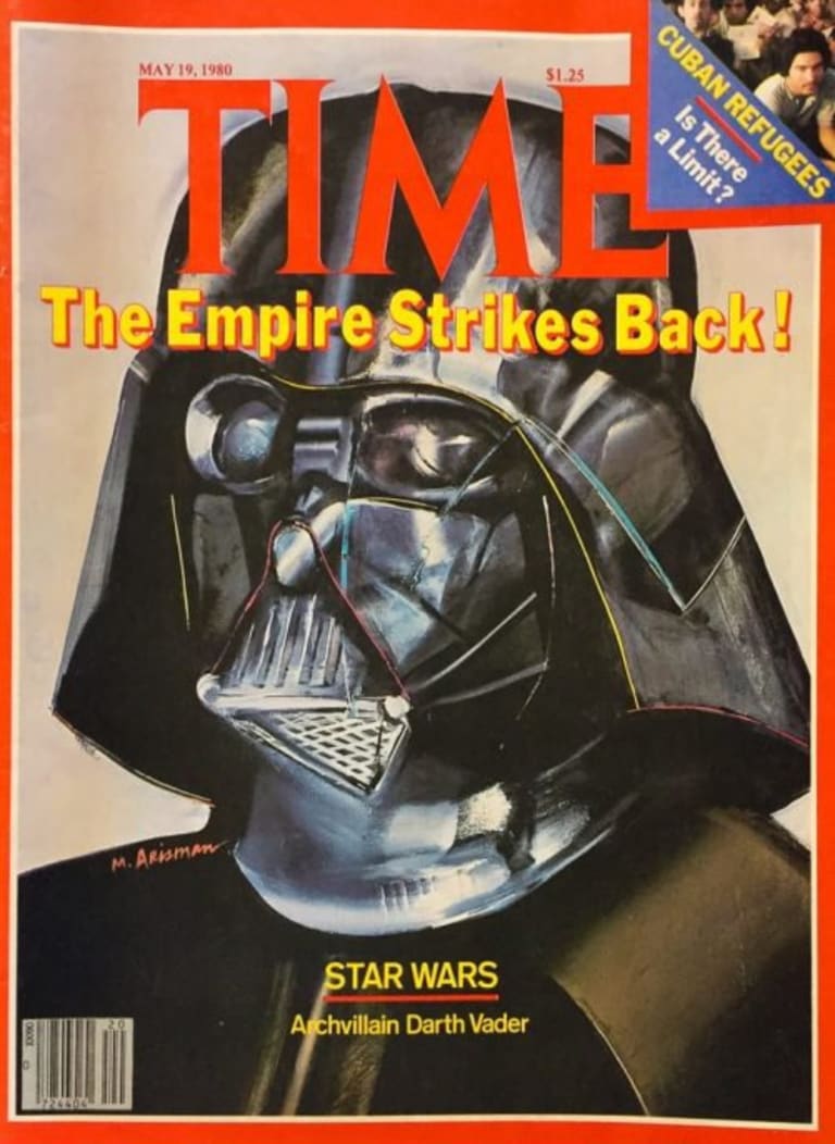 Time Magazine cover depicting Darth Vader's head. Top corner has a fold over showing a crowd of people.