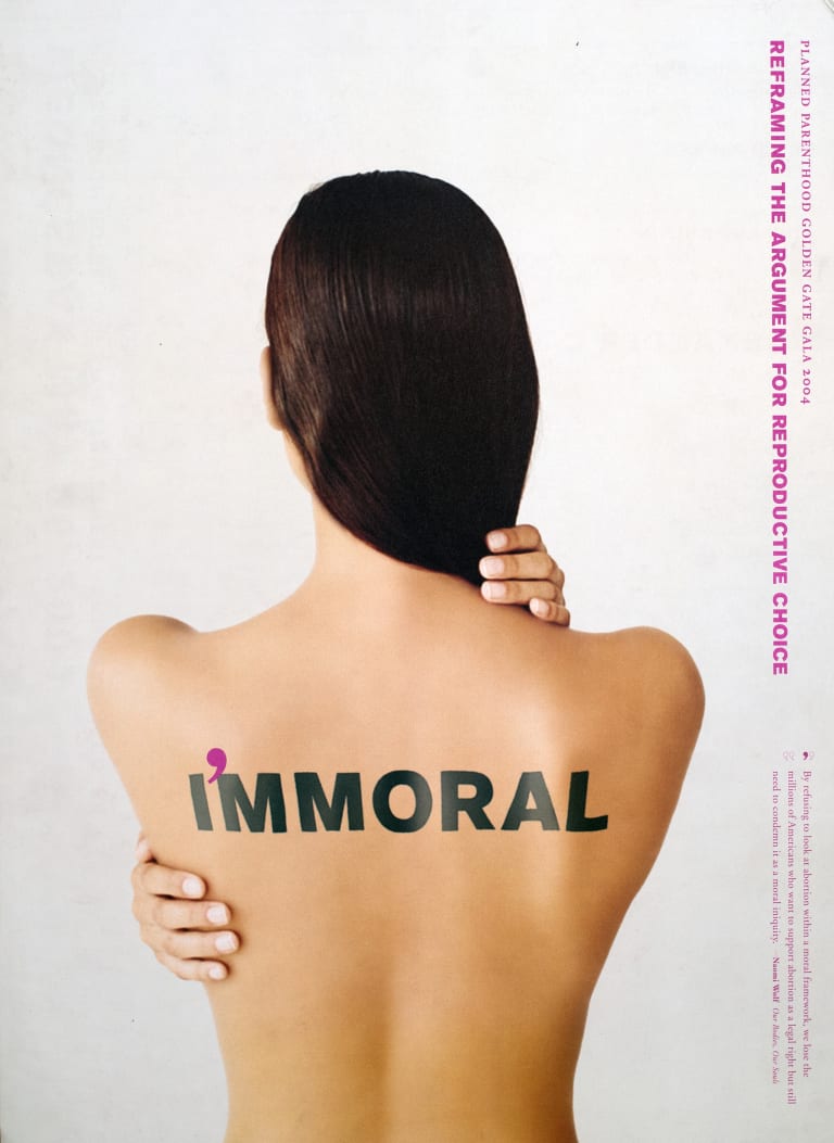 <p "="">A photograph of a woman's bare back with the phrase "I'mmoral" written on it.
