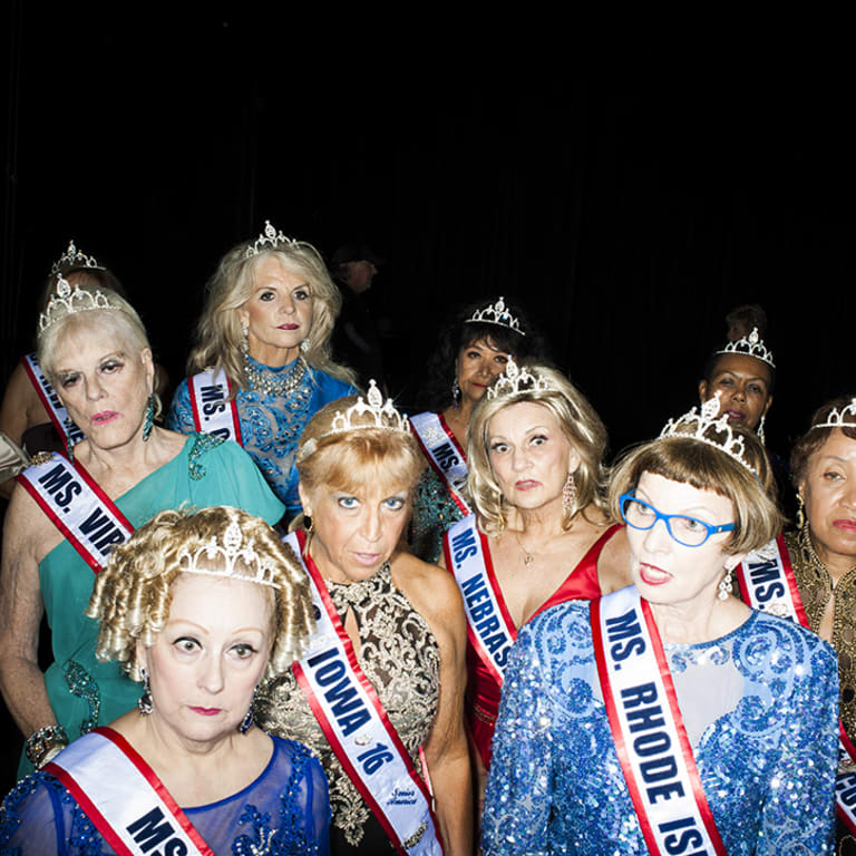 Pictures of pageant contestants. Most of them are wearing a visible sash that has a state on it, all women are wearing makeup and a crown.