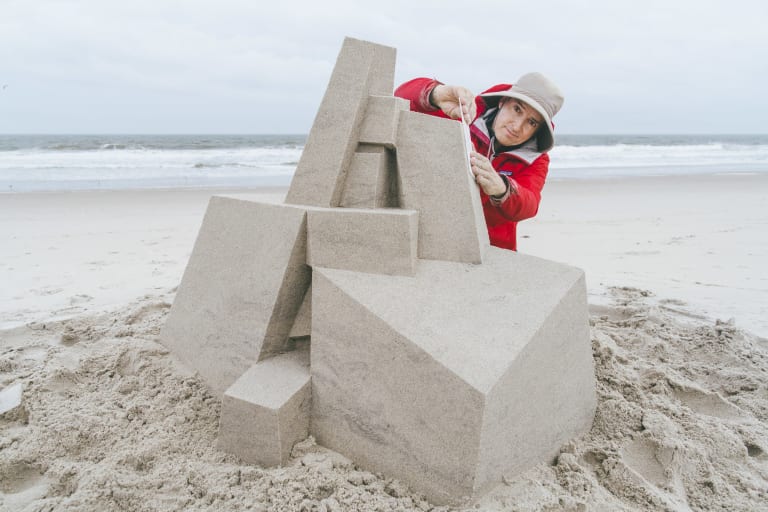 <p "="">SVA alumnus Calvin Seibert puts the finishing touches on a sandcastle sculpture at Rockaway Beach, Queens.
