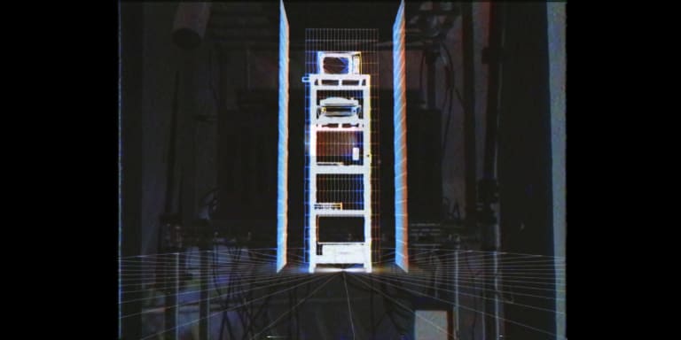 A still of Santiago Messier's documentation video of his installation Control: The Illusion of. The image is an analog computer imagery of his multimedia installation equipment reflecting the style of computer art in the early 1980s.

