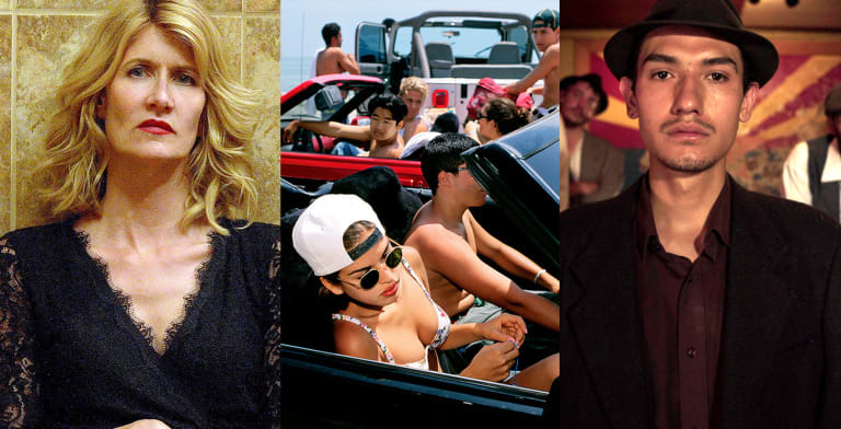A blonde woman wearing makeup stands against a tiled brown wall. Friends cruise with their cars tops down on a hot summer day. A man wearing a hat with a thin goatee gazes into the camera while his friend, also wearing a hat, looks on from behind.