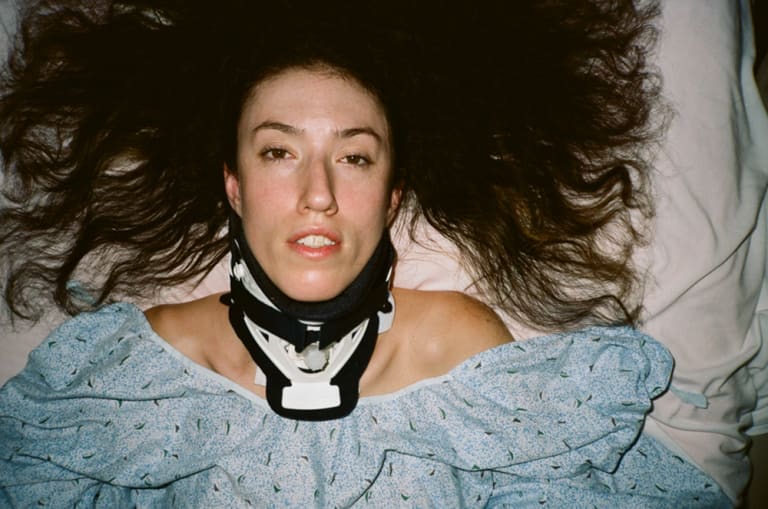 A woman laying down with a neck protection