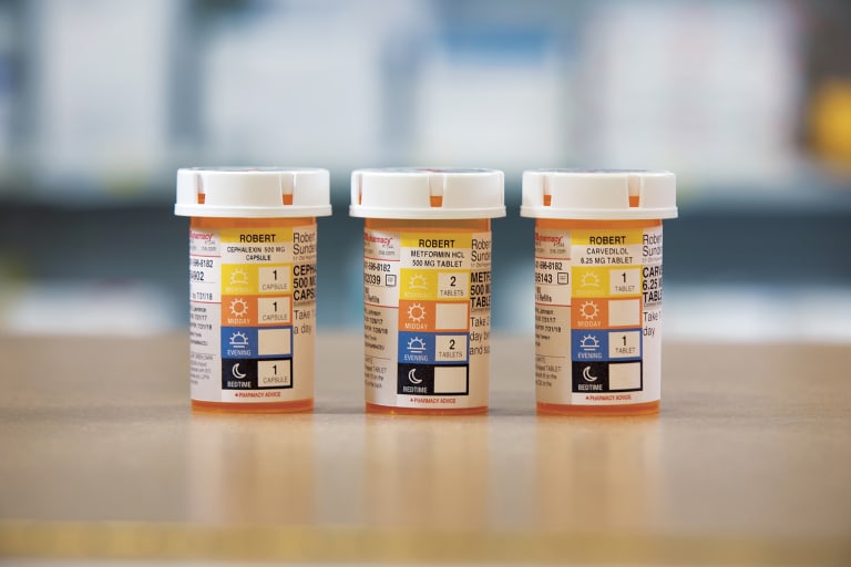 Three prescription pill bottles featuring time-of-day dosage labeling.