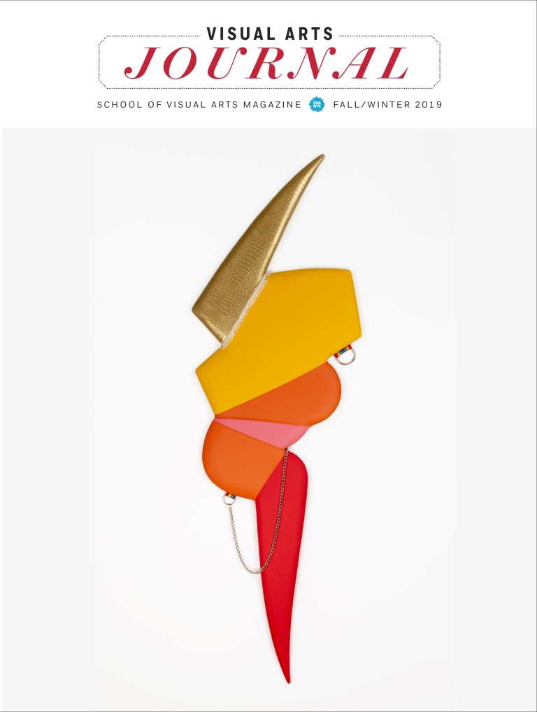 <p "="">A cover of a magazine, featuring a lightning-bolt shaped sculpture with gold, yellow, orange, pink and red colors.
