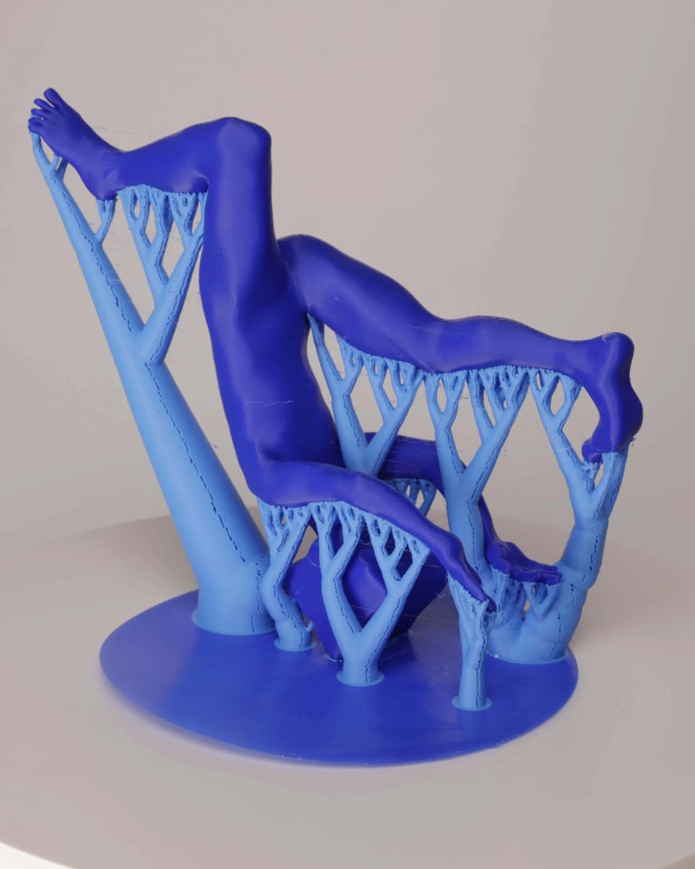 3D-printed in blue plastic human form flipping upside down on top of the 3D-printed support.