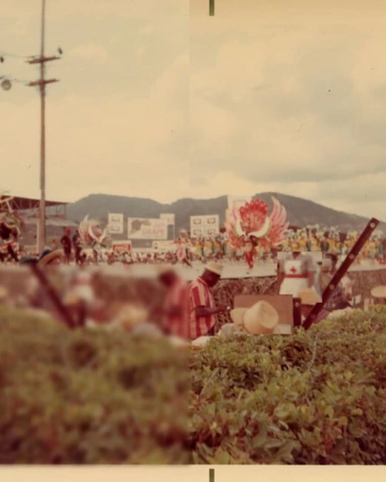 Archival photograph of a crowd at a celebration outside with people watching performers in costumes. Parts of the photograph are blurred to obscure identities.