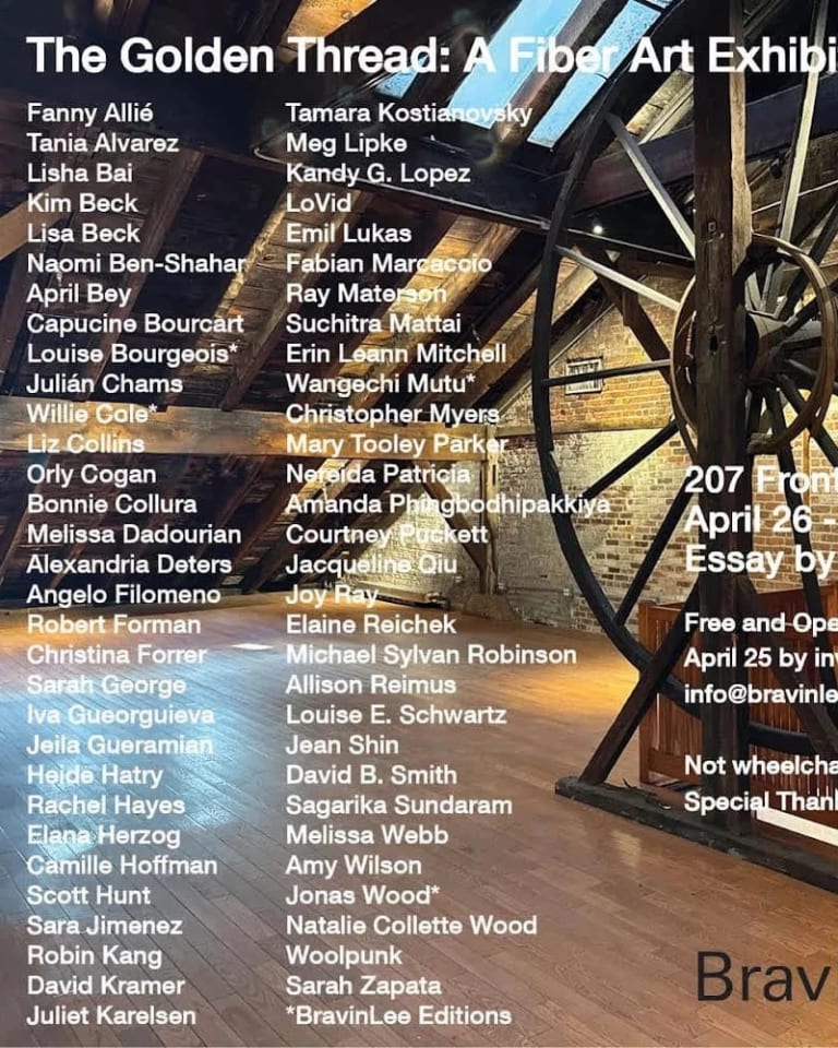 Exhibition invitation with venue information and artists’ names in white font over a color photograph of an enormous wooden factory wheel inside a room with a brick walls, a slanted ceiling, and a wood floor.