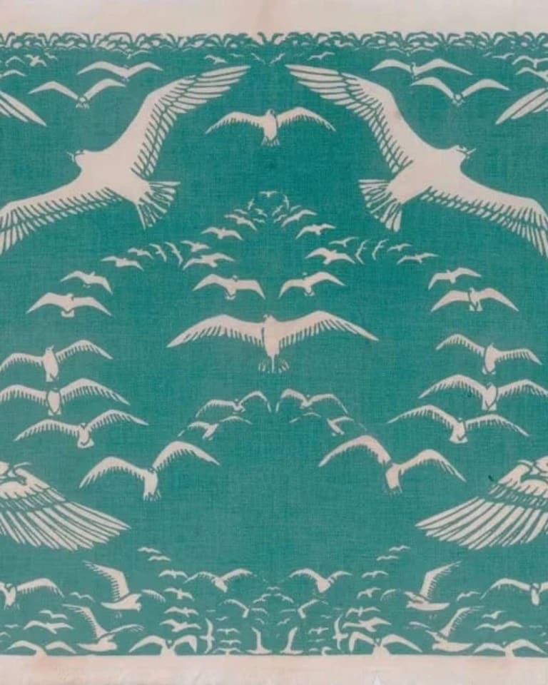 Light blue print of sea gulls in an upside-down heart formation.