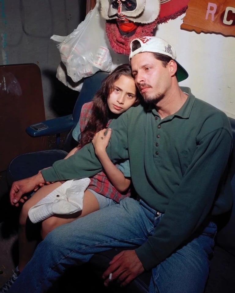 Father and daughter sit together tenderly in their backyard shed in New York's Lower East Side.