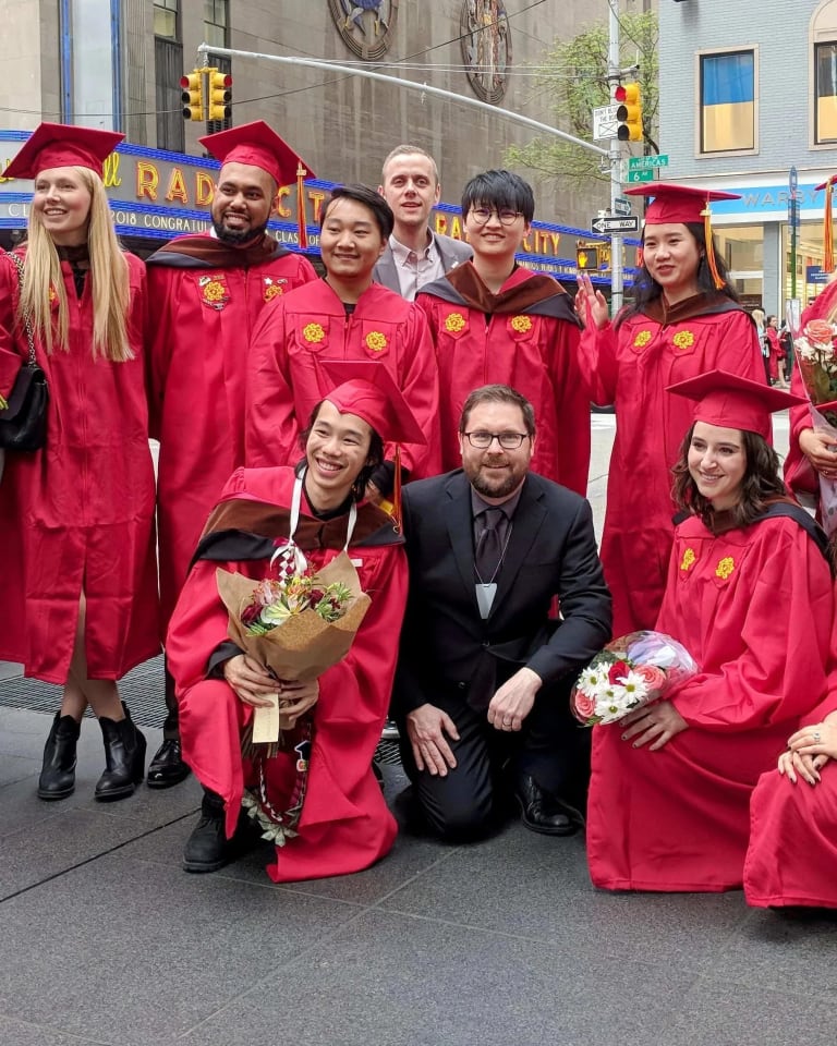 The graduating MPSDP class of 2019 stands on the street with the Radio City Music Hall in the background.