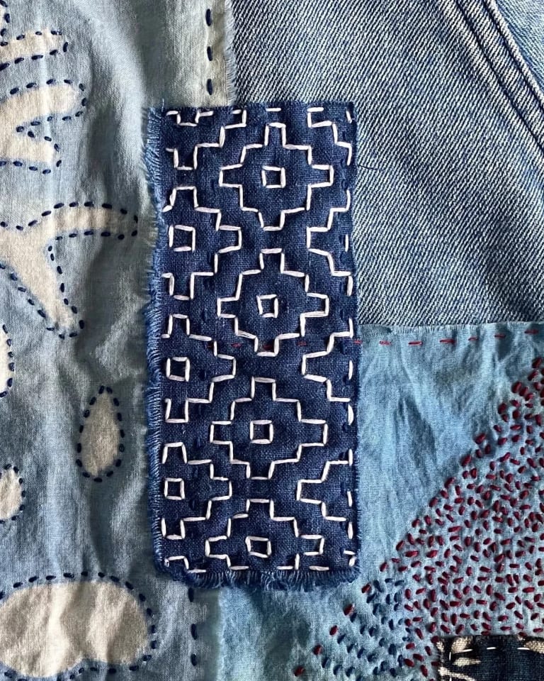 Image of fabric dyed in indigo with intricate patterns