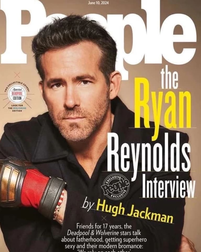 Two men, one in a gray shirt on the left, the one on the right in black, fist bump each other wearing colorful gloves while staring at the camera on the cover of 'People' magazine. 
