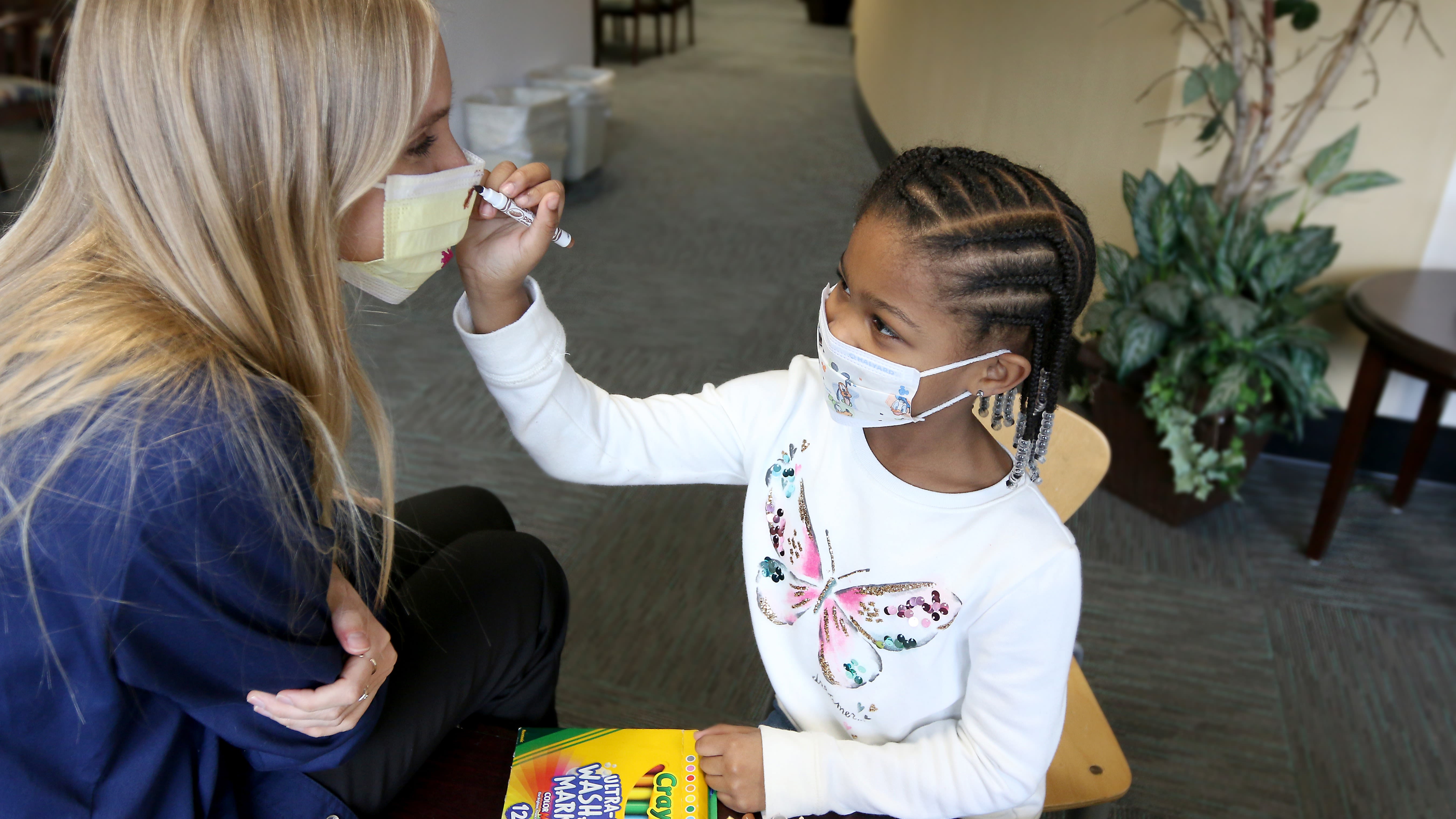 Student and teaching both wearing masks.
