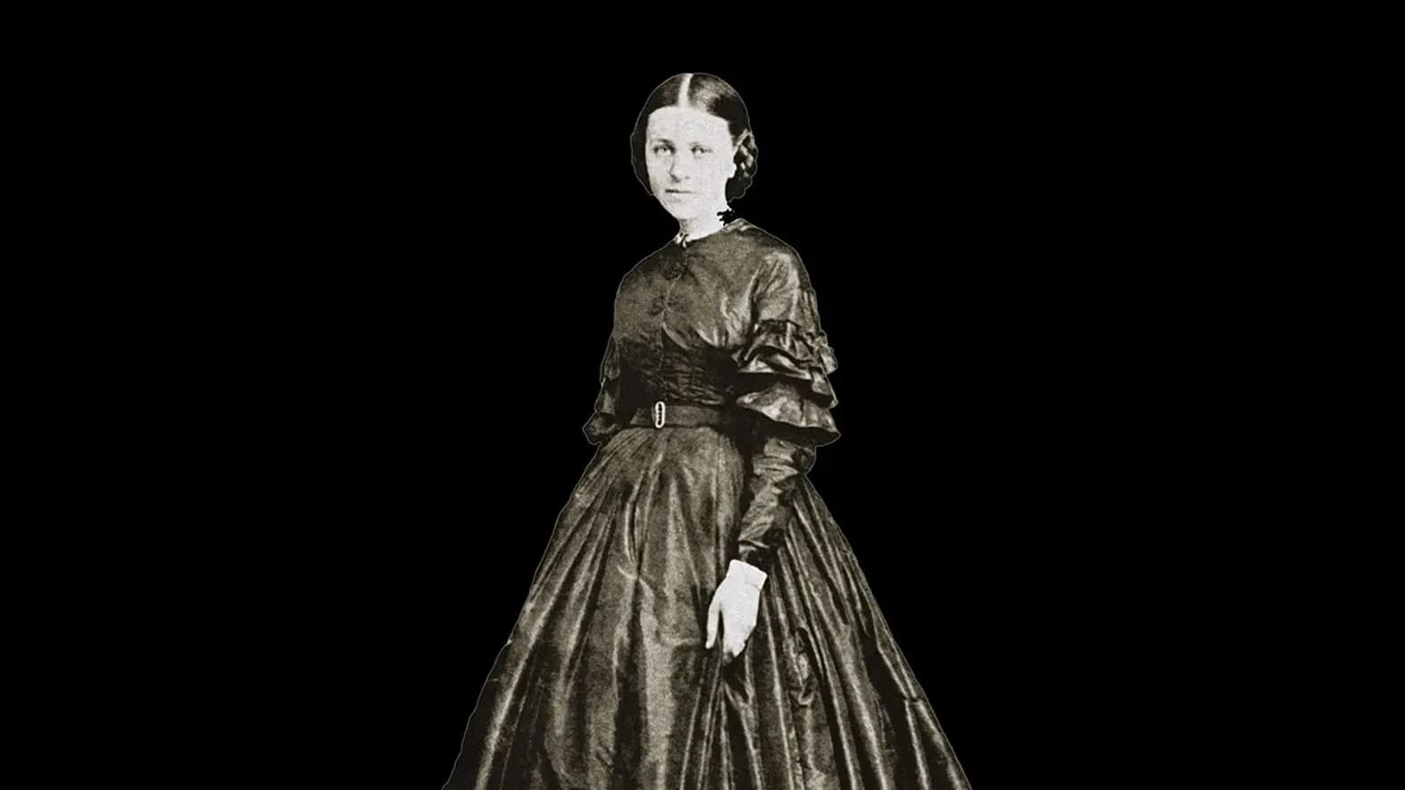 A black and white photograph of a 19th century woman against a black background.