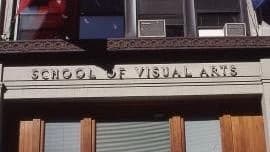 The front of the school of visual arts building has a red flag on the left and a blue flag on the right.