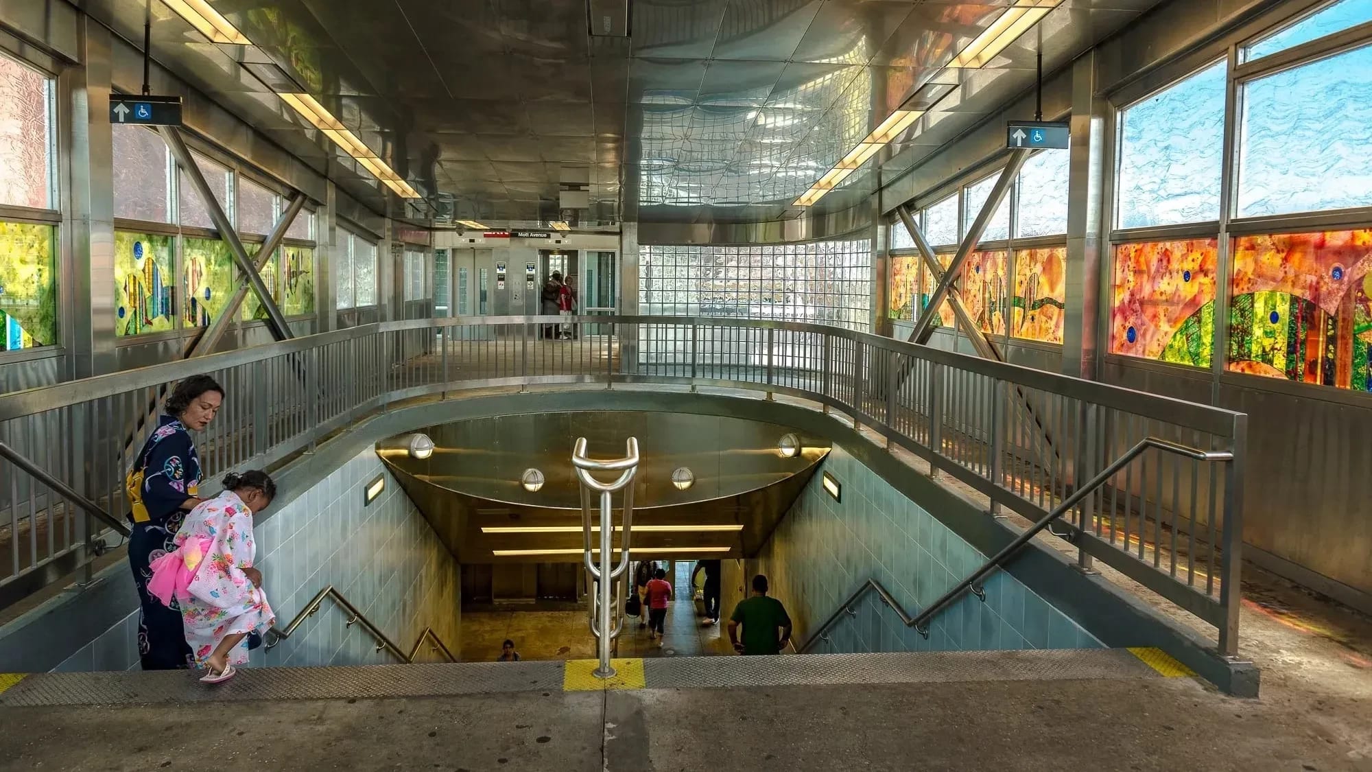 Photo of Far Rockaway Mott Avenue station, two people wearing kimonos. 