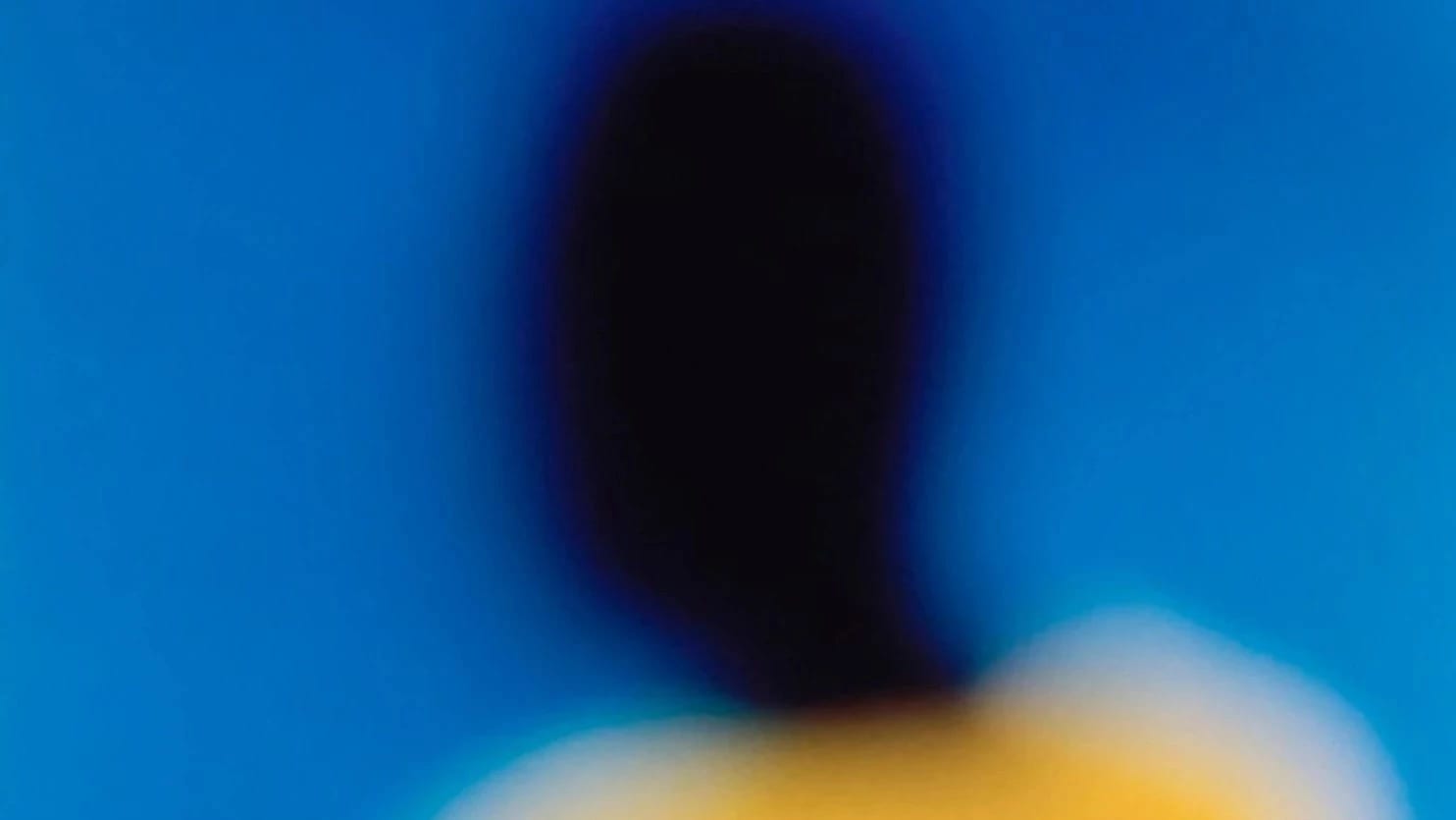 a yellow, blue and magenta portrait of a figure with a dark face.