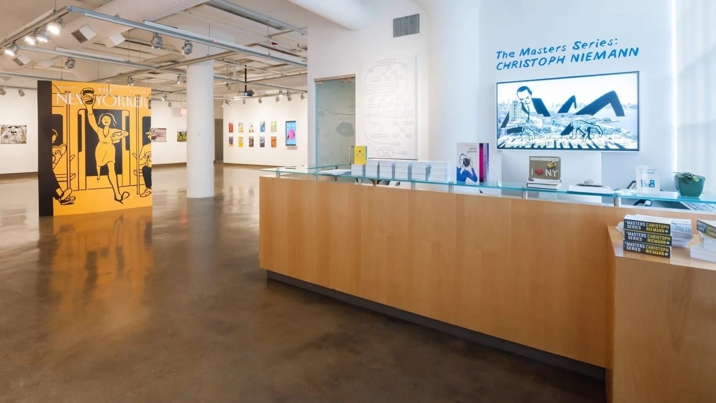 The reception desk at an art gallery featuring Christoph Niemann.