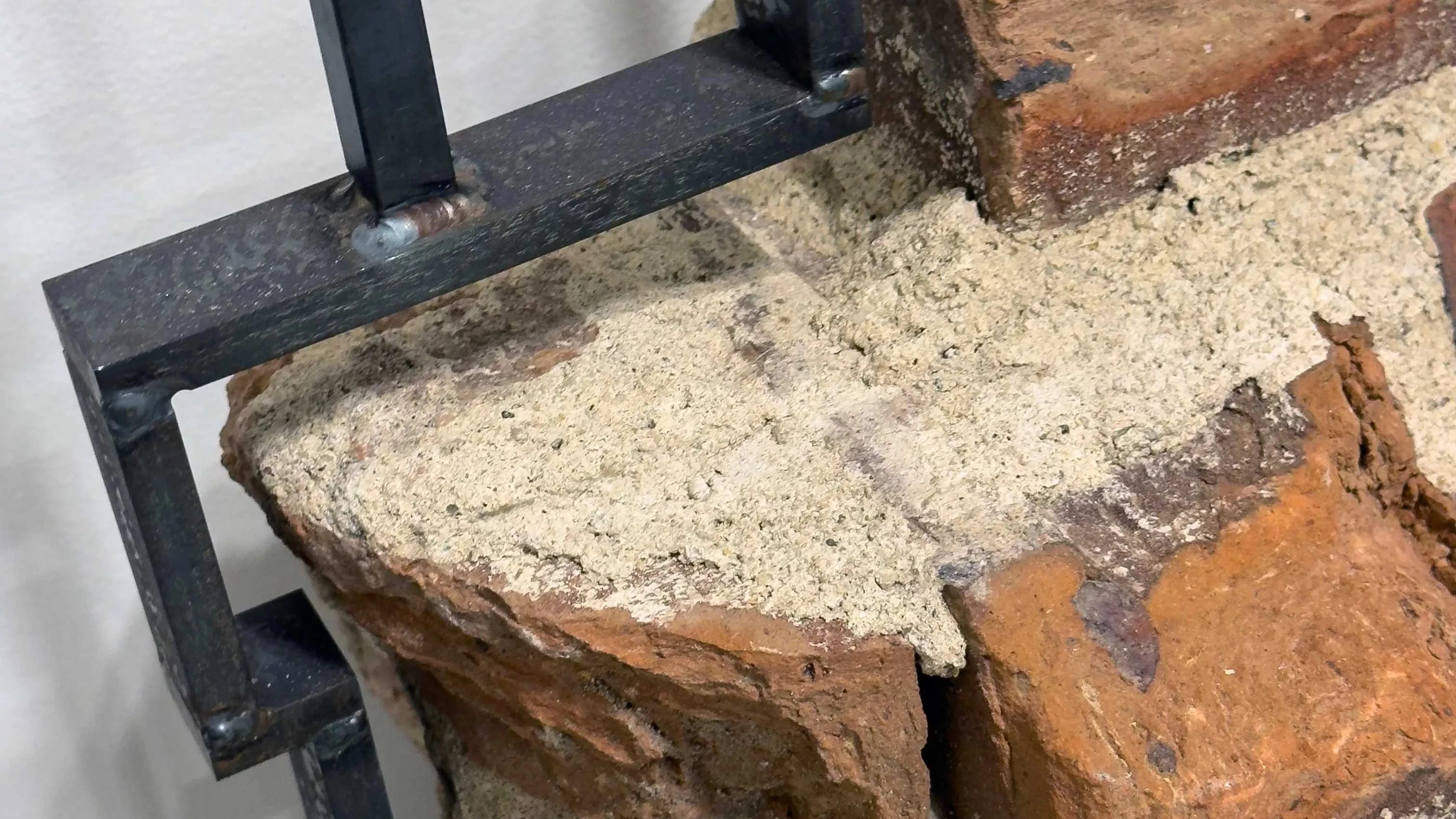 Detail image of a sculpture made of bricks over an iron armature.