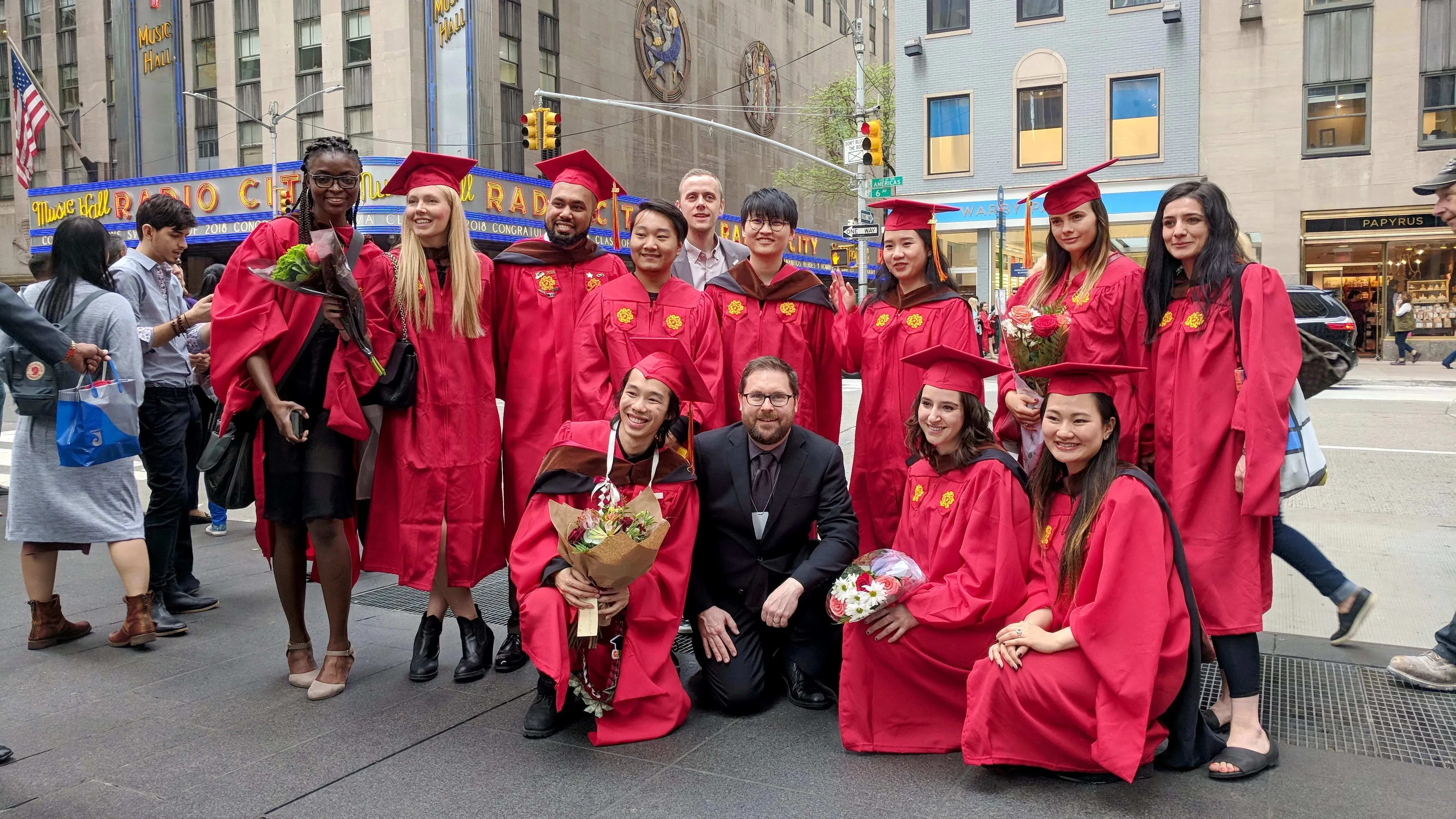 The graduating MPSDP class of 2019 stands on the street with the Radio City Music Hall in the background.