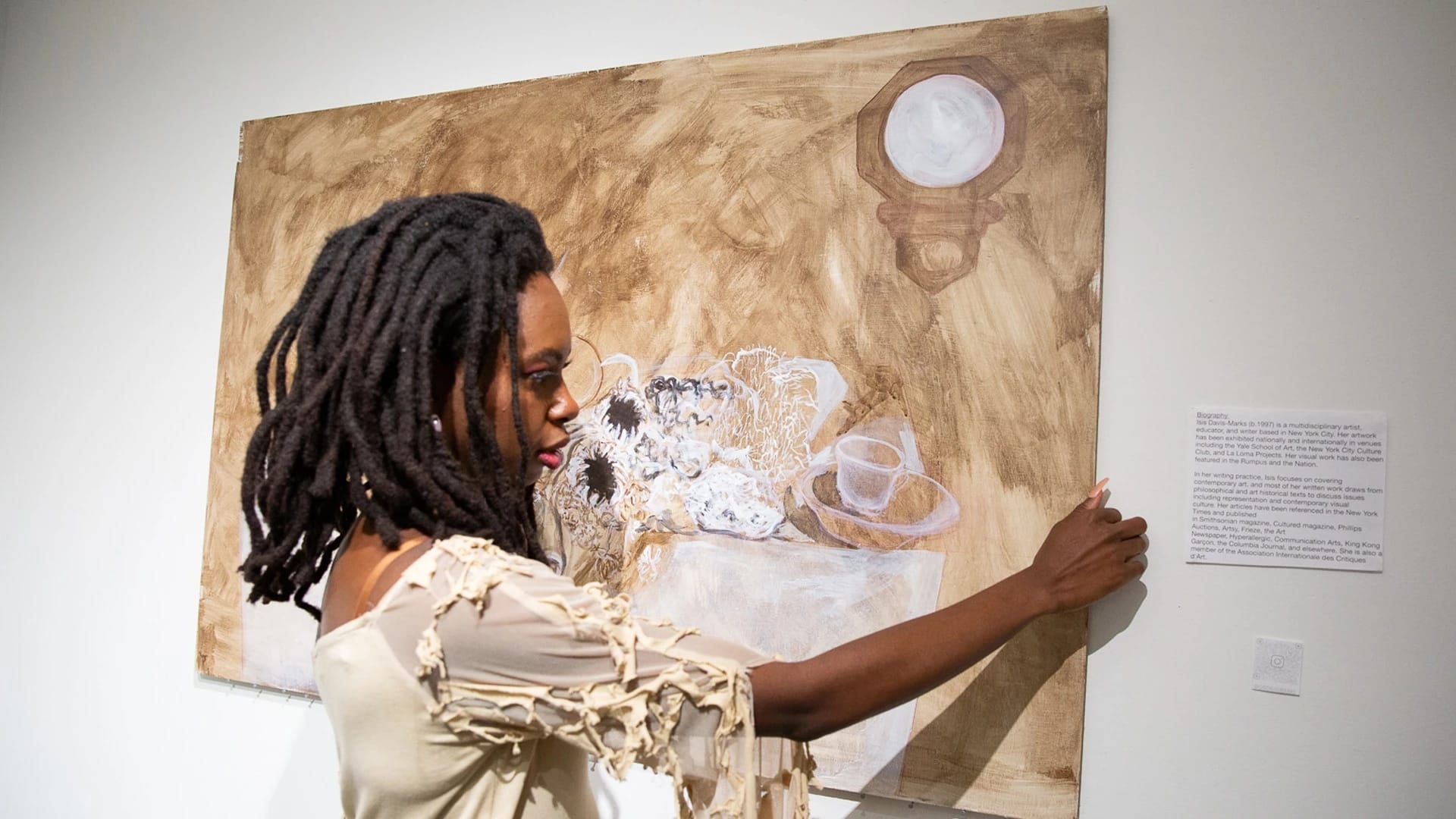 students moving their painting on the wall