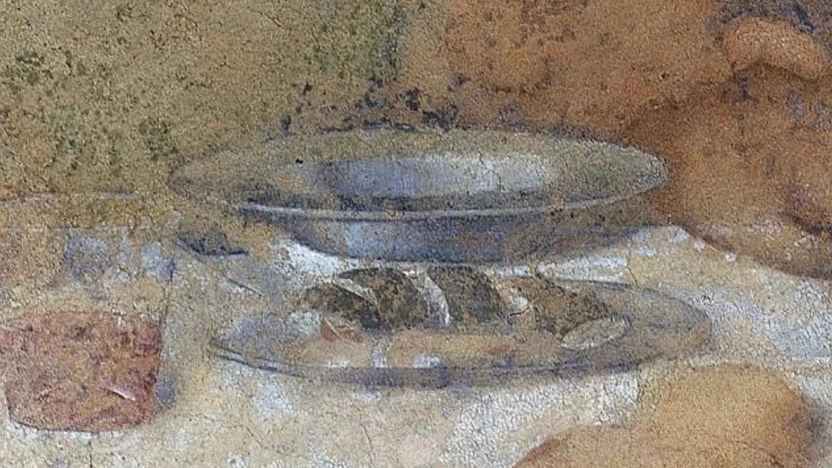 Grainy image of a bowl and bread, a detail from Leonardo Davinci's "Last Supper"