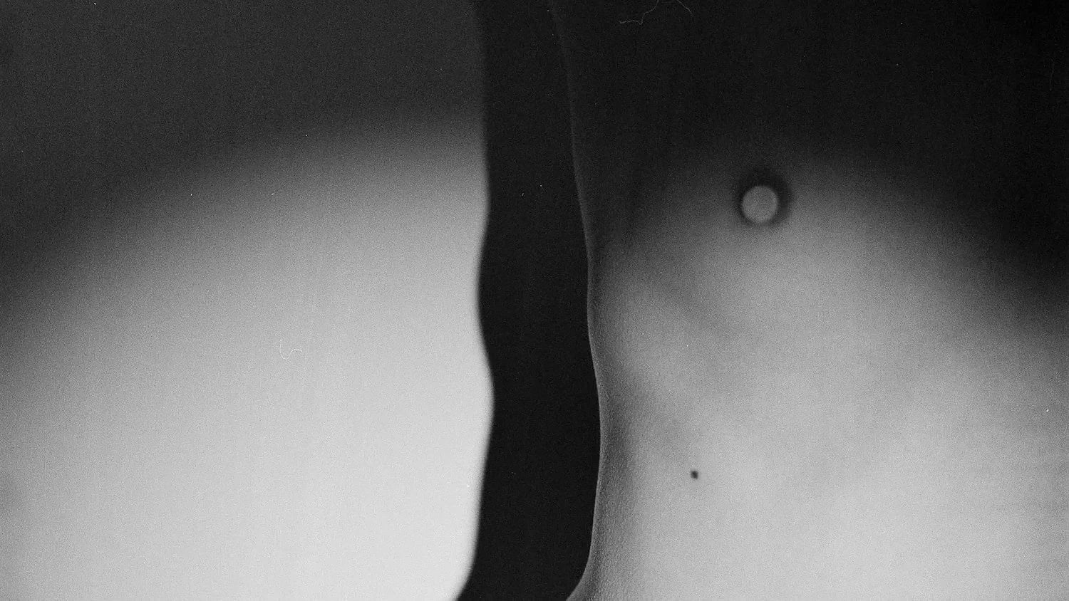 Close-up of a human torso with a visible belly button.