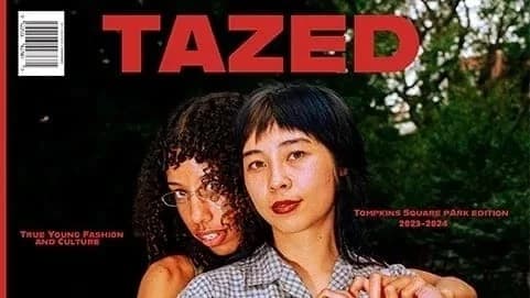 One person has her arms around another person. Both make a heart sign with their hands.