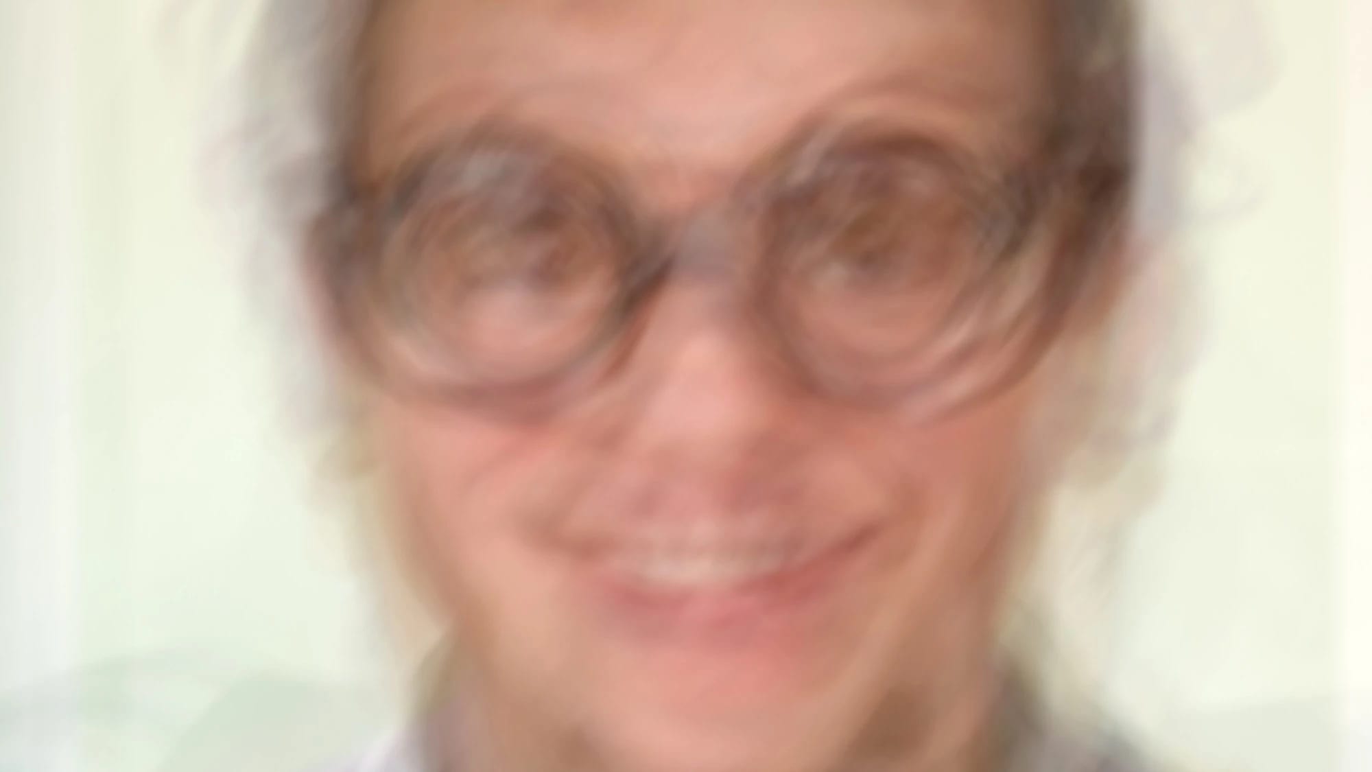 A digital overlapped composite of multiple photographs of a nerd, creating a blurred image of the subject.