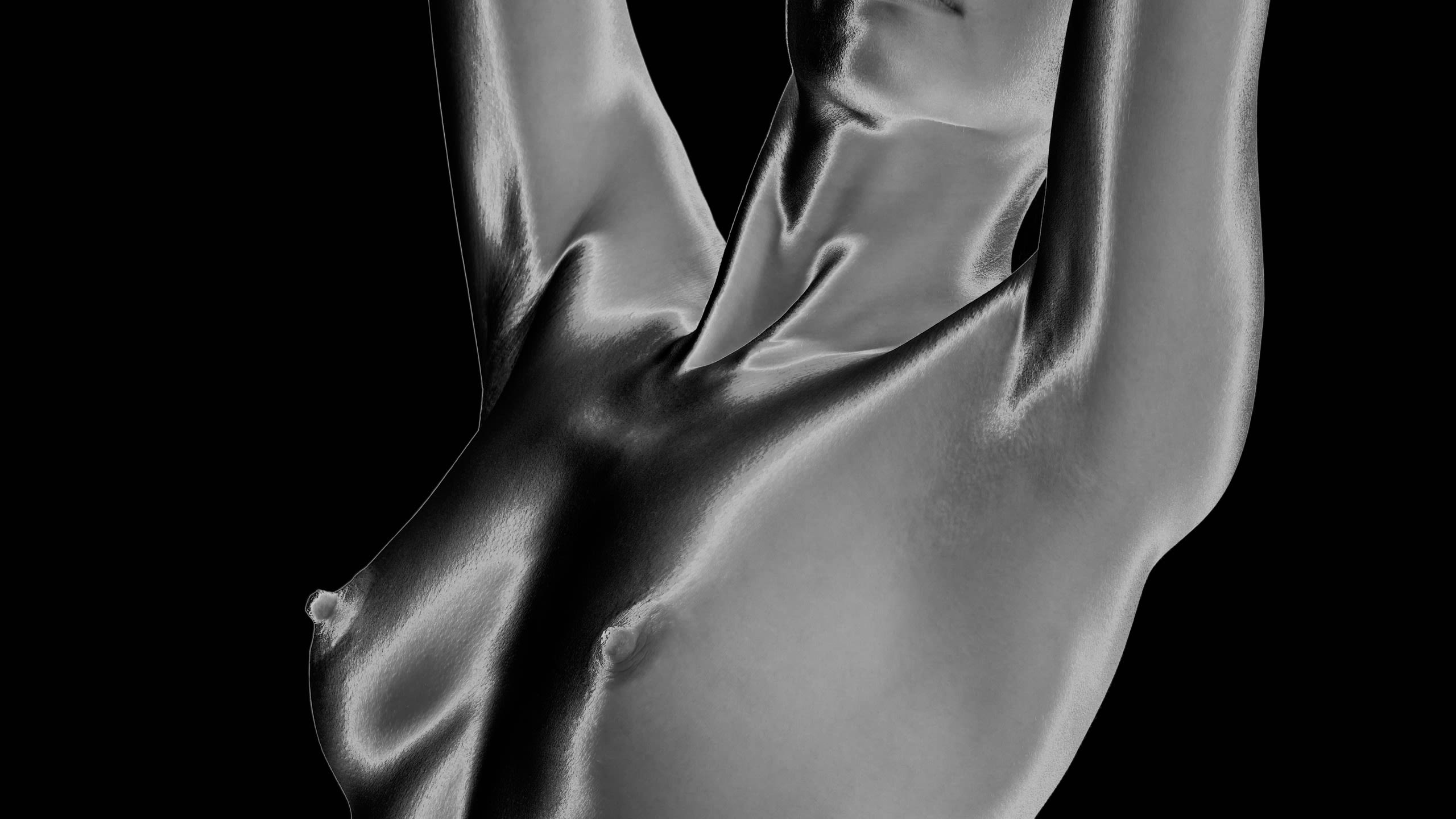 A black-and-white diptych of the same image. It is a woman’s nude torso from the knees to her chin. She is in profile with her front leg and arms raised. The versions on the left and right are negatives of each other, with one on a black background and on white background.