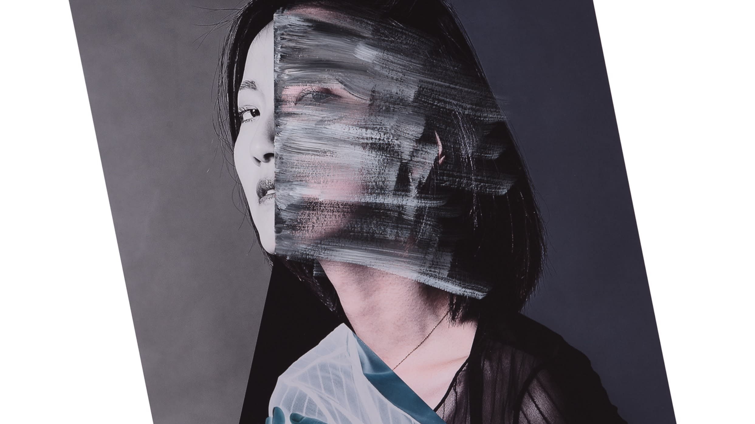 An abstract photograph of a portrait of a woman seated in three-quarter view, looking at the camera. The photograph is half the size of the frame, and is rotated to the left slightly, and is against a white background. The back half of the portrait is black and white. The front half is in color. Over the color portion of the woman’s face, there is white and black paint streaked over it. There is a triangle shape intersecting the image from the woman’s chin, to the bottom of the portrait, to outside of the portrait image. Inside the triangle is a color-inverted image of the woman’s shoulders and hand from a different photograph, against a black background. There is a splatter of dark blue paint in the black part of the image. Black is bleeding from the triangle down and off the bottom of the frame.