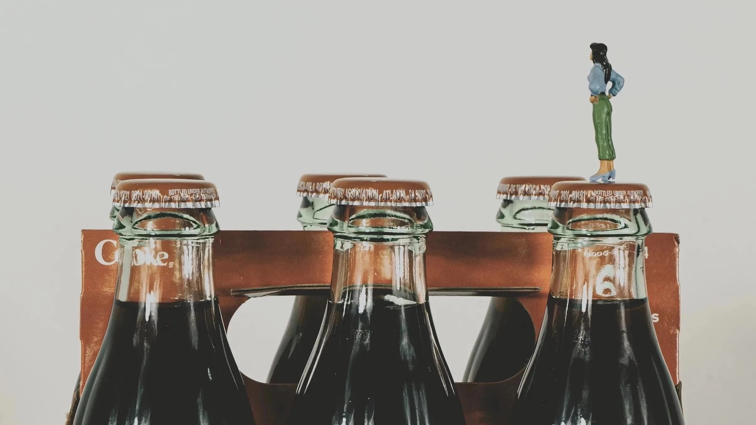 Still life, miniature standing on Coca-Cola product